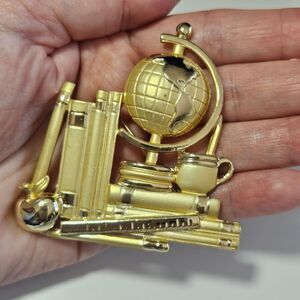 AJC gold tone books and globe brooch office school